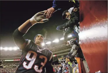  ?? TNS - Steven Frischling ?? Richard Seymour shakes hands with the fans as he walks around Gillette Stadium following the Patriots’ victory over the Chargers in the 2008 AFC Championsh­ip Game.