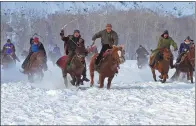  ??  ?? Herdsmen take part in a winter horse race.