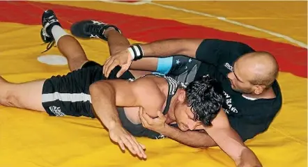  ?? DYLAN LUCRE-SCOTT ?? Wrestlers Akash Khullah, in black T-shirt, and Jordan Rose from the Tawa Tigers. Khullah has been chosen to represent New Zealand at the Commonweal­th Games. Tigers coach Scott Laurenson