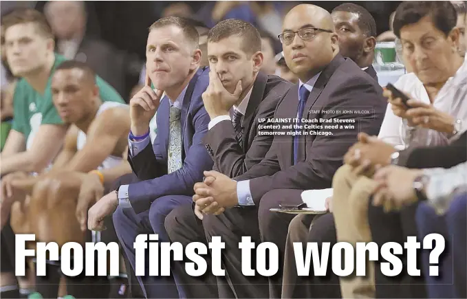  ?? STAFF PHOTO BY JOHN WILCOX ?? UP AGAINST IT: Coach Brad Stevens (center) and the Celtics need a win tomorrow night in Chicago.