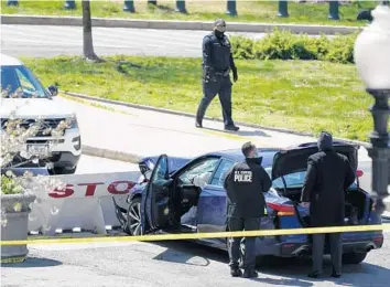  ?? APPLEWHITE | AP J. SCOTT ?? U.S. Capitol Police officers stand near a car that crashed into a barrier Friday on Capitol Hill in Washington.