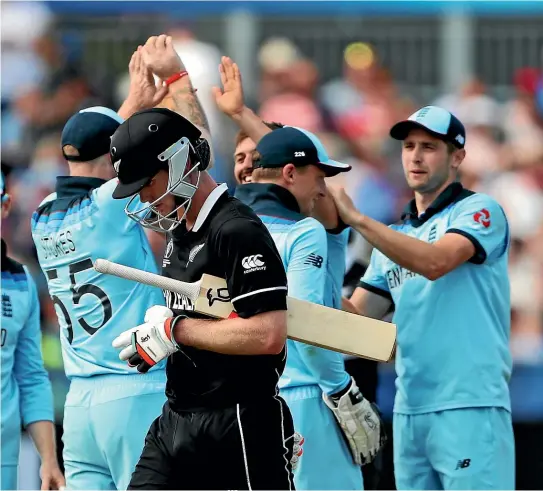  ?? AP ?? Jimmy Neesham walks off after his dismissal as New Zealand slump to a heavy defeat against England.