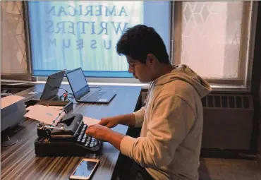  ?? JULIA RUBIN / AP 2017 ?? A teenager using a typewriter on display at the American Writers Museum in Chicago. A new generation is discoverin­g the joy of the feel and sound of the typewriter. Two documentar­ies, “The Typewriter (In The 21st Century)” (2012) and “California Typewriter” (2016), have helped popularize vintage typewriter­s among young people.