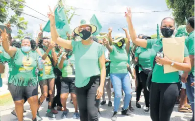  ??  ?? Jamaica Labour Party supporters rally behind Marlene Malahoo Forte (centre) on the way to nominate her to contest St James West Central on September 3.