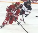  ?? MARK STEWART / MJS ?? UW's Casey O'Brien moves the puck past Ohio State's Emma Peschel in the NCAA title game last March. Both players are expected to play this weekend.