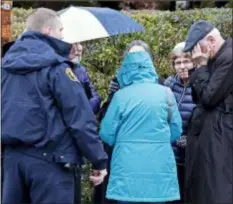  ?? GENE J. PUSKAR - THE ASSOCIATED PRESS ?? People gather on a corner near the Tree of Life Synagogue in Pittsburgh, where a shooter opened fire Saturday.