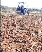  ?? ?? A tractor ploughing a field.