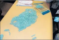  ?? COURTESY OF DEA ?? Stamped to look like OxyContin, the blue pills seized by the DEA were filled with heroin.