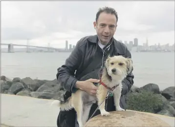  ?? ERIC RISBERG — THE ASSOCIATED PRESS ?? Timothy Ray Brown stands with his dog, Jack, on Treasure Island in San Francisco.