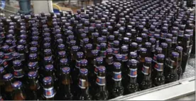  ?? LABATT BREWERIES VIA THE CANADIAN PRESS ?? Bottles of Labatt Blue come off the line at the Labatt brewery in London.