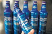  ?? Associated Press file photo ?? Brewers explain it this way: Beer requires a can, which requires aluminum. Tariffs sending aluminum prices up, raise can costs.
