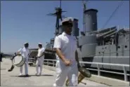  ?? THANASSIS STAVRAKIS — THE ASSOCIATED PRESS ?? Members of a naval band leave the 107-year-old battleship “Georgios Averof” after its arrival at Trocadero marina in southern Athens on Wednesday.