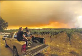  ?? NOAH BERGER — THE ASSOCIATED PRESS ?? Thomas Henney, right, and Charles Chavira watch a plume spread over Healdsburg, Calif., as the LNU Lightning Complex fires burn earlier thisweek.