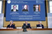  ?? JONAS EKSTROMER / TT NEWS AGENCY ?? Secretary General of the Royal Swedish Academy of Sciences Hans Ellegren (center), Eva Olsson (left) and Thors Hans Hansson of the Nobel Committee for Physics announce the winners of the 2022 Nobel Prize in Physics: Alain Aspect (left on the screen), John F. Clauser and Anton Zeilinger.