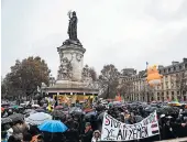  ?? ZAKARIA ABDELKAFI/GETTY-AFP ?? People gather during a protest against President Donald Trump on Sunday at the Place de la Republique in Paris.