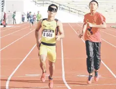  ??  ?? Sarawak’s Filemon Lirong Dionisus (left), with his guide, competes in the men’s 400m T11 (visually impaired) during the Perak Para Sukma at Stadium Perak in this Nov 26 file photo. He won the race in 63.21sec. — Bernama photos