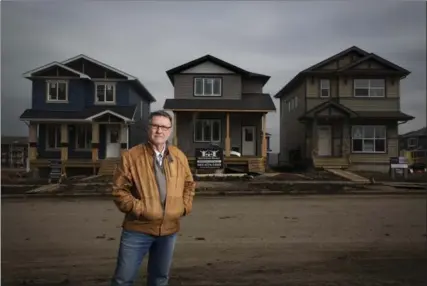  ?? TODD KOROL, THE CANADIAN PRESS ?? Builder Gilles Huizinga, at a housing developmen­t in progress in the Timberlea area of Fort McMurray.