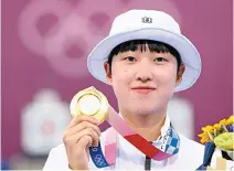  ?? Yonhap ?? Olympic champion An San poses with her gold medal after the award ceremony for the women’s individual archery of the 2020 Tokyo Olympics in Tokyo, July 30, 2021.