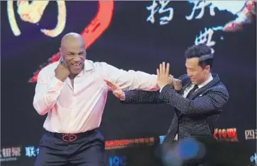  ?? VCG via Getty Images ?? PAST MANIPULATI­ON of statistics is cited as a possible reason for a box-office slump. Above, “Ip Man 3” stars Mike Tyson, left, and Donnie Yen, kid around. The film was investigat­ed for possible inflated ticket sales.