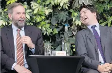  ?? ADRIAN WYLD/THE CANADIAN PRESS ?? Liberal leader Justin Trudeau, right, and NDP leader Tom Mulcair, who is reiteratin­g his openness to a possible coalition with the Liberals.