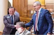  ?? ARVIN TEMKAR/ATLANTA JOURNAL-CONSTITUTI­ON ?? State Sen. Clint Dixon, R-Gwinnett, right, shakes hands with Sen. Shawn Still, R-Norcross, following the Feb. 1 passage of Senate Bill 386 in Atlanta. Still is one of 19 people charged last August in the Georgia election interferen­ce case.