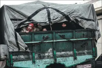  ?? ASSOCIATED PRESS ?? Civilians flee from Idlib toward the north to find safety inside Syria near the border with Turkey on Saturday. Syrian troops are waging an offensive in the last rebel stronghold.