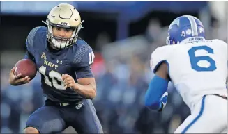  ??  ?? Navy quarterbac­k Malcolm Perry, left, runs with the ball as Air Force defensive back Zane Lewis moves in for the hit during the Midshipmen's 34-25 win Oct. 5. [AP PHOTO/JULIO CORTEZ]