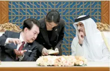 ?? Yonhap ?? President Yoon Suk Yeol, left, speaks to Emir of Qatar Tamim bin Hamad Al Thani at Amiri Diwan in Qatar during his state visit to the country, Oct. 25, 2023.