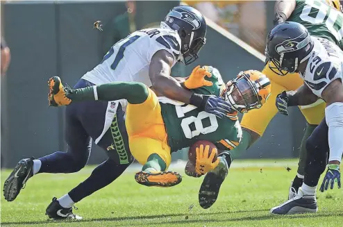  ?? RICK WOOD / MILWAUKEE JOURNAL SENTINEL ?? Packers wide receiver Randall Cobb secures one of his nine receptions on Sunday. He saw a game-high 13 targets against Seattle’s defense.