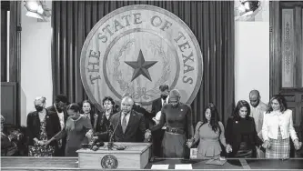  ?? Sam Owens/staff photograph­er ?? Rep. Carl Sherman leads a closing prayer during a news conference held by members of the Texas Legislativ­e Black Caucus last month who spoke out against Gov. Greg Abbott’s order for state agencies to eliminate diversity policies in hiring.