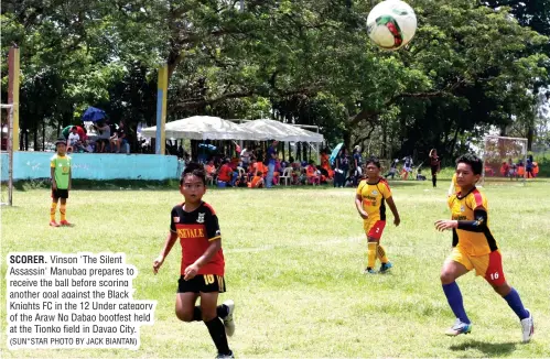  ?? (SUN*STAR PHOTO BY JACK BIANTAN) ?? SCORER. Vinson 'The Silent Assassin' Manubag prepares to receive the ball before scoring another goal against the Black Knights FC in the 12 Under category of the Araw Ng Dabao bootfest held at the Tionko field in Davao City.