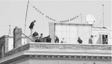  ??  ?? People are seen on the rooftop at the Consulate General of Russia in San Francisco, California. — Reuters photo