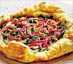  ?? ANDREW RUSH / PITTSBURGH POST-GAZETTE ?? This broccoli, red pepper and pesto galette is really just a laid-back pie.