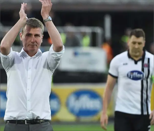  ??  ?? Stehen Kenny and Brian Gartland cross the pitch to salute fans after Dundalk’s 1-1 draw with Rosenborg at Oriel Park last week.