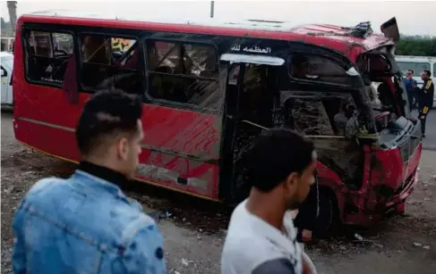  ?? (Reuters) ?? Emergency services recover a mini-bus from ac anal in Egypt yesterday after almost two dozen people were killed in the accident
