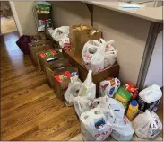  ??  ?? Some of the donations collected for the Zuber Realty food drive.