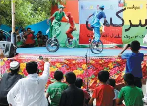  ?? MASSOUD HOSSAINI / AGENCE PRANCE-PRESSE ?? Afghan youngsters from the Mobile Mini Circus for Children perform during a show in Paghman district on the outskirts of Kabul on Friday. Children from the circus held entertainm­ent programs in the Afghan capital and other big cities.