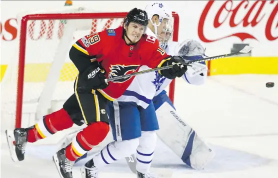  ?? JIM WELLS ?? Flames forward Matthew Tkachuk battles defenceman Nikita Zaitsev in front of the Toronto Maple Leafs net Tuesday night at the Scotiabank Saddledome. The Maple Leafs won 4-1.