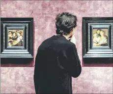  ?? — acm photo ?? a person looks at painting during the preview of the exhibition ‘Rembrandt’s four senses – his first paintings’ in the de iakenhal museum in ieiden.