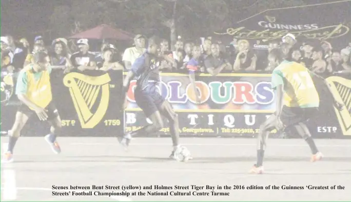  ??  ?? Scenes between Bent Street (yellow) and Holmes Street Tiger Bay in the 2016 edition of the Guinness ‘Greatest of the Streets’ Football Championsh­ip at the National Cultural Centre Tarmac