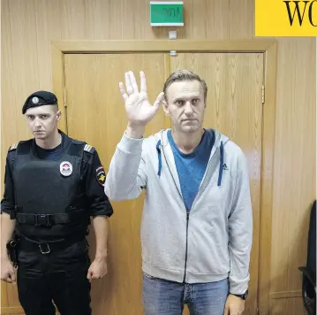  ?? PAVEL GOLOVKIN / THE ASSOCIATED PRESS ?? Russian opposition leader Alexei Navalny, shown here in a Moscow courtroom on Monday, has been sentenced to a month in jail for unsanction­ed protests held in January. This is the second 30-day jail term for Navalny this year.