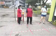  ??  ?? Among the measures in place at SM Wong Nai Siong is readying hand sanitiser at the front gate.