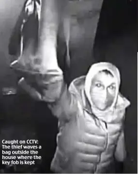  ??  ?? Caught on CCTV: The thief waves a bag outside the house where the key fob is kept