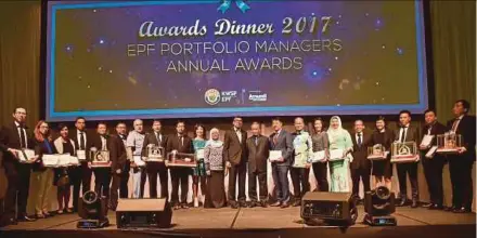  ??  ?? Employees Provident Fund chairman Tan Sri Samsudin Osman (tenth from right) with EPF chief executive officer Datuk Shahril Ridza Ridzuan (eighth from right), officials and winners of the EPF Portfolio Managers Awards for last year in Kuala Lumpur on...