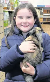  ??  ?? All smiles Ava McLeod and furry friend Hugh Dressed to impress Royalheart volunteers Christine Jones and Arlene Burt with Mouse and Badger