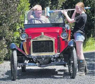  ?? PHOTO: GERARD O’BRIEN ?? Making new memories . . . Emma Boult (15) gives her father Phill’s 1913 Alldays and Onions car a clean, in preparatio­n for this year’s Dunedin to Brighton Veteran Car Rally.