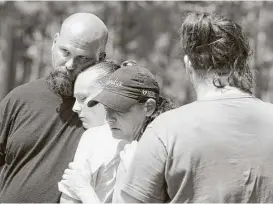  ?? Jason Fochtman ?? Michael Kiser, left, and his family mourn the death of his sister, Theresa Kirkpatric­k, who went missing Friday.