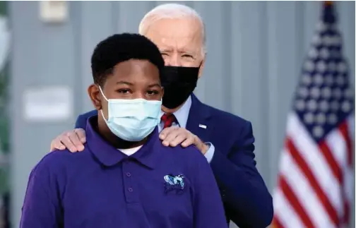  ?? Agence France-presse ?? US President Joe Biden greets a student prior to speaking about coronaviru­s protection­s in schools during a visit to Brookland Middle School in Washington.