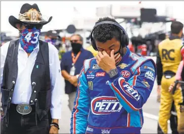  ?? John Bazemore Associated Press ?? BUBBA WALLACE, right, gets emotional next to team owner Richard Petty. Wallace, the only Black driver in the NASCAR Cup Series, has spoken out against the Confederat­e f lag, which was still visible on race weekend.