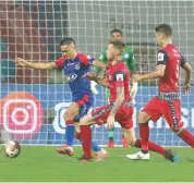  ??  ?? Bengaluru FC’s Sunil Chhetri (left) vies for the ball with Jamshedpur FC defenders in their ISL match at the JRD Tata Sports Complex in Jamshedpur on Sunday.